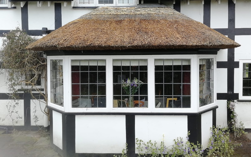 Thatched roof after moss has been removed